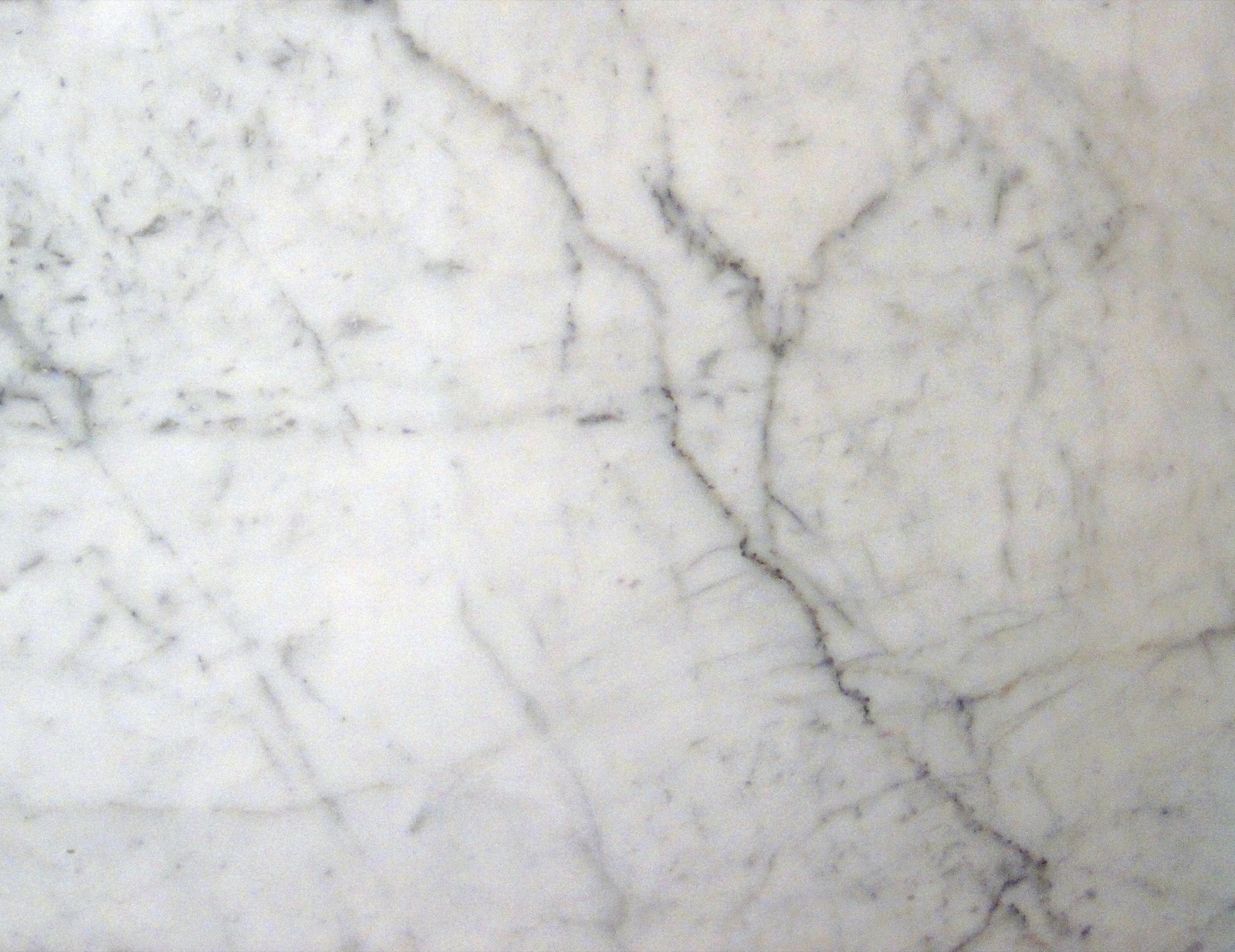 Polished slab of Carrara-region Statuarietto marble, soft grey veining on a white ground