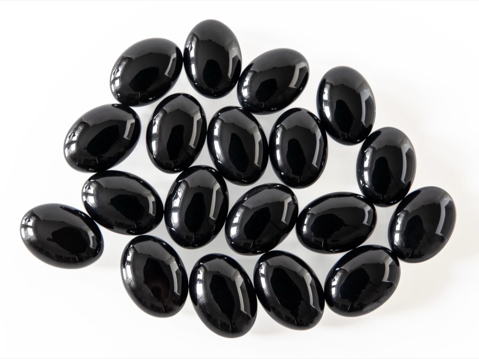 Polished black onyx cabochons, deep uniform black with a soft sheen